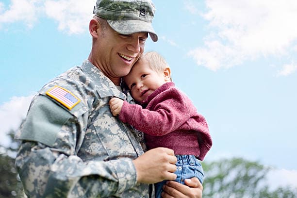 Military service member holding child